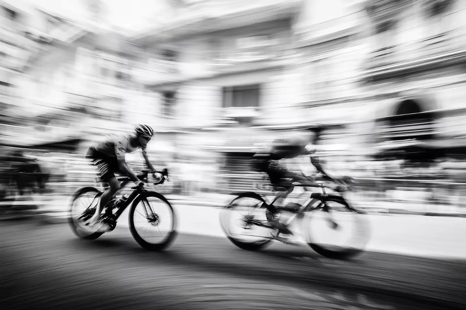 Two riders in motion, black and white
