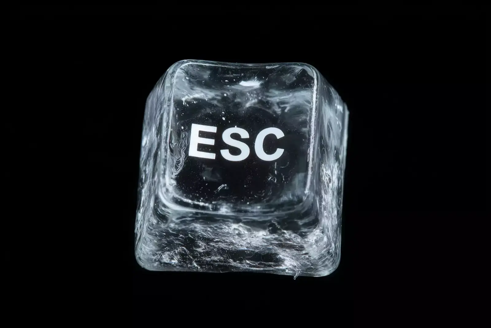 An escape key frozen inside a block of ice